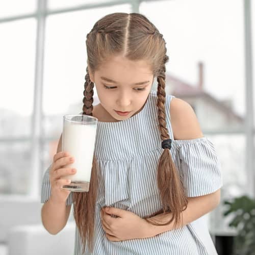 Young girl feeling ill after drinking milk - possible dairy allergy