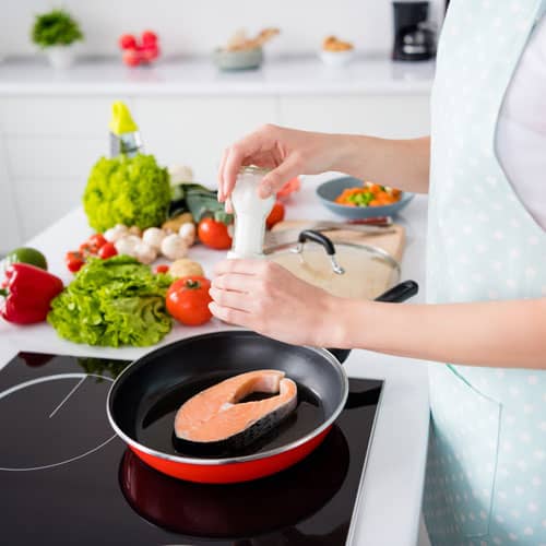 Mum cooking healthy meal for her kids